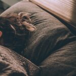 The Sleep-Performance Connection: Why Rest Is the Key to Better Leadership woman sleeping on bed under blankets